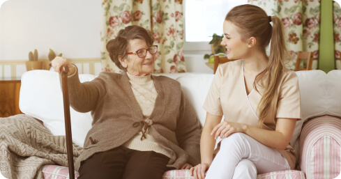 caregiver having conversation with elderly woman